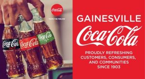 hand holding three types of coca cola