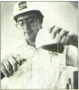 man in a hard hat testing coca cola