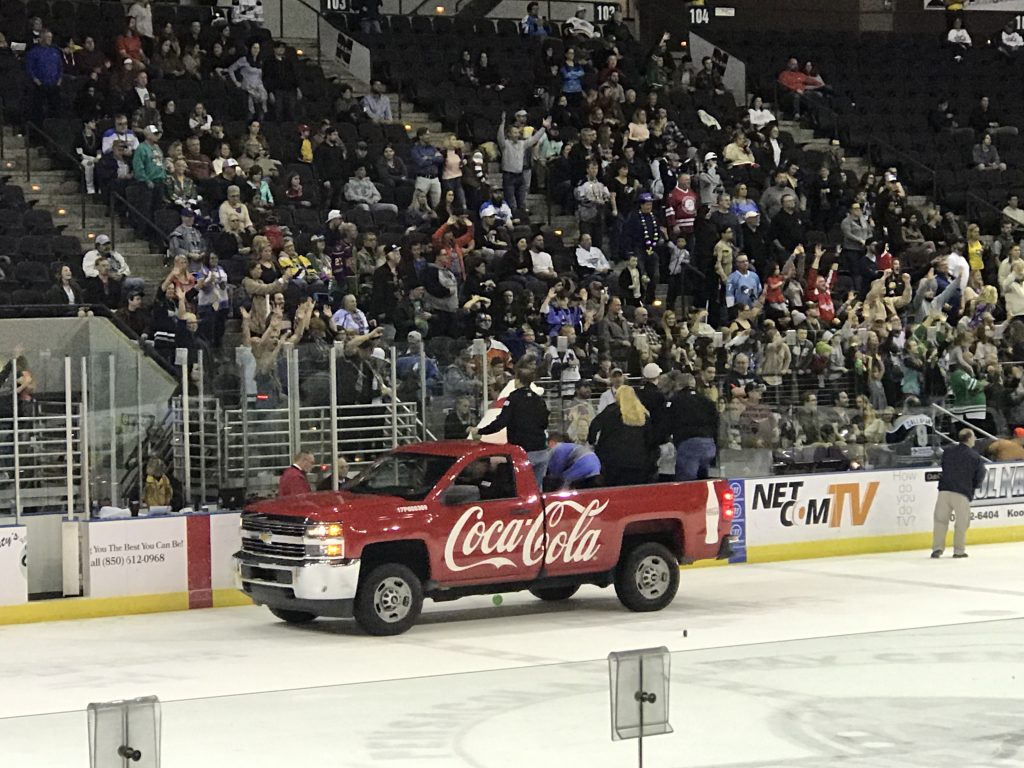 The excited crowd tries to catch beads thrown from the Coca-Cola truck