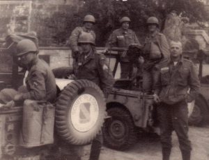 several military men in jeeps